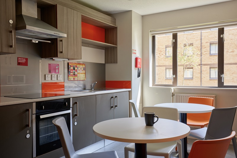 Tables and chairs in a shared kitchen in Scholars Green Halls
