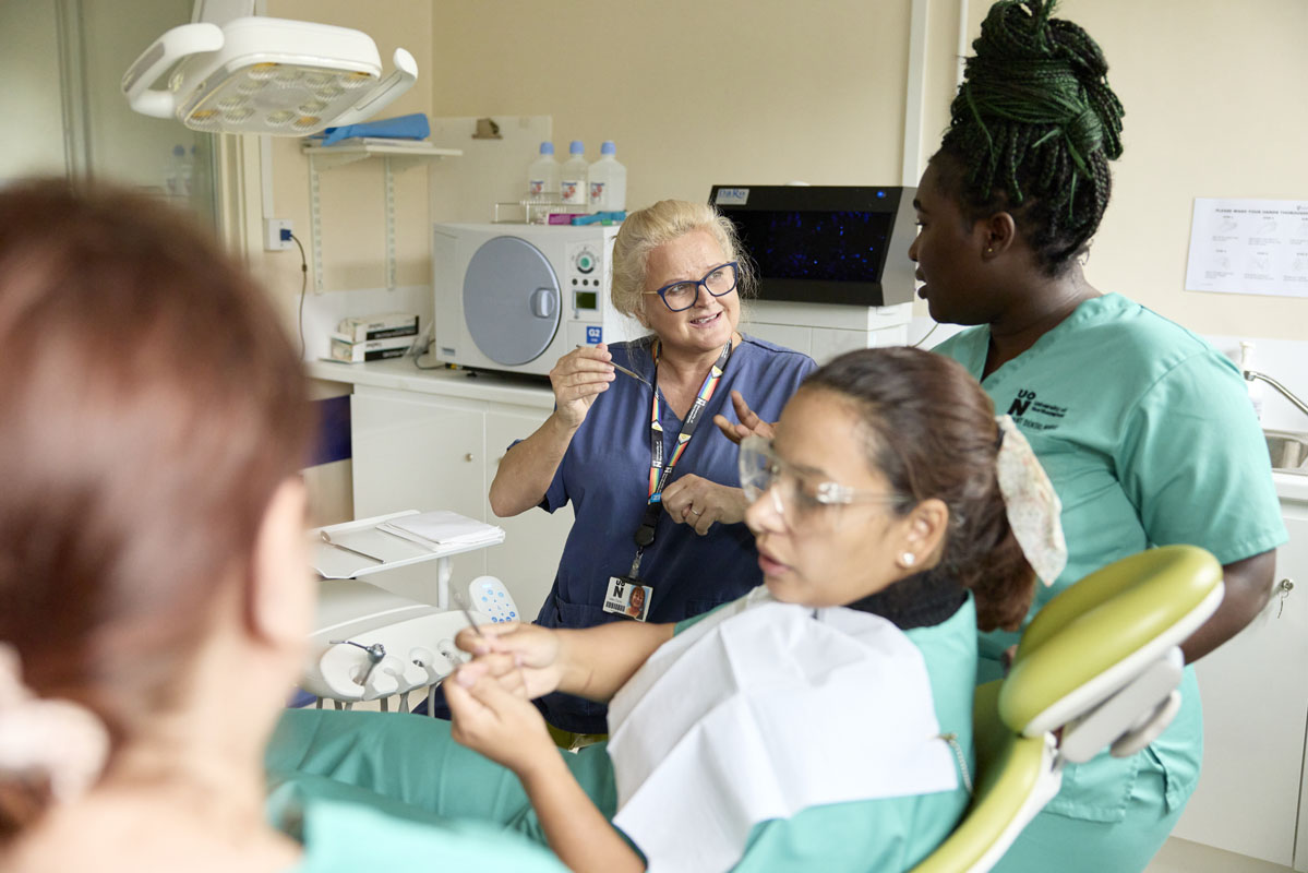 Students and Dental Nursing academic in a practice session with a patient in the Dental Nursing Simulation space at NGH