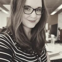 An image of Financial Guidance Team's Belinda Bradshaw in a striped top and glasses.