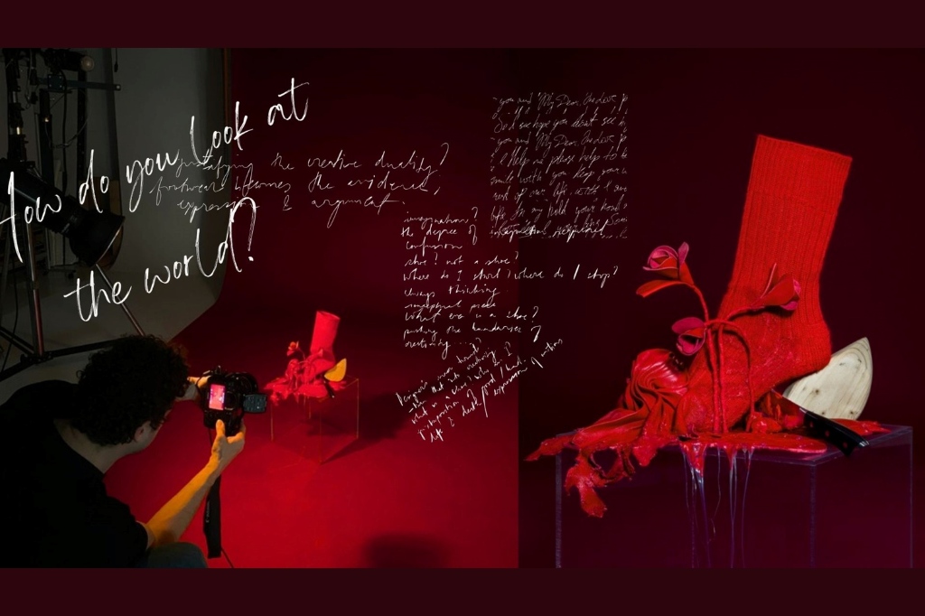 A photographer captures a red high-heeled shoe with matching sock on display; handwritten text overlays the image on a deep red background.